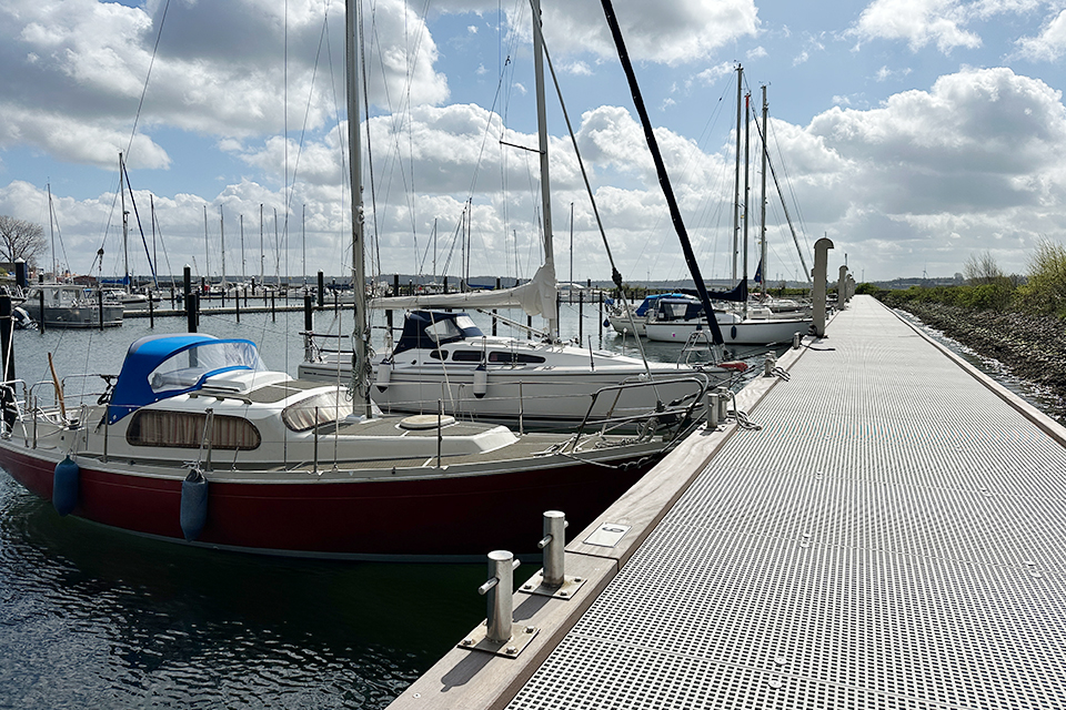 Jetty with GRP decking, sailing boats moored alongside